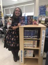 Aileen Basuljevic displays the monthly book crate from Scholastic